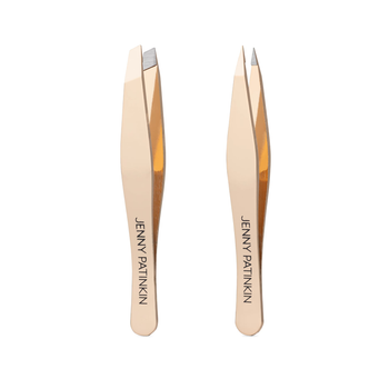 A pair of metallic gold-toned precision tweezers with the brand name 'JENNY PATINKIN' printed vertically on the handles, set against a plain white background.
