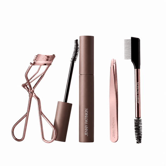 Jenny Patinkin Big Reveal eye beauty bundle featuring eyelash curler, mascara, slanted tweezers, and dual-ended lash and brow comb
